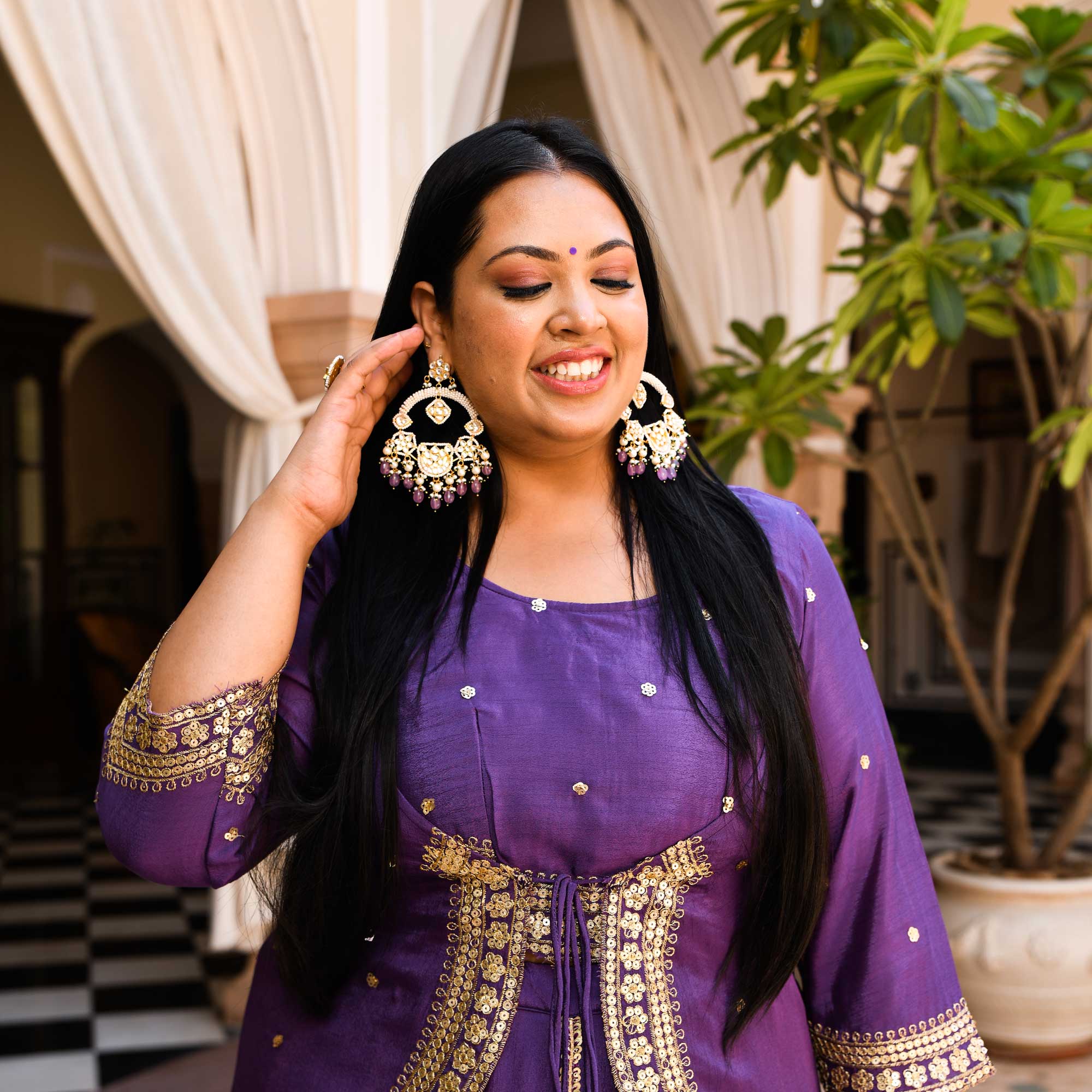 Photo of A bride in maroon lehenga and gold jewellery